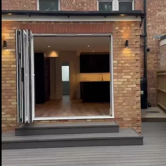 Brick rear extension with open bi-fold doors and new decking