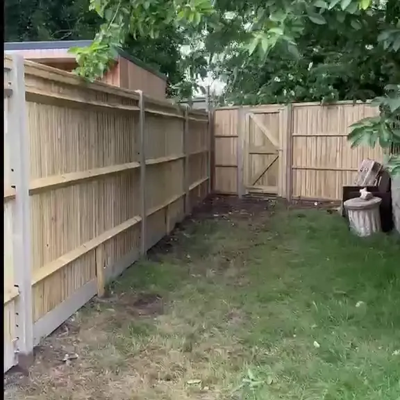 New close-board timber fence along a back garden
