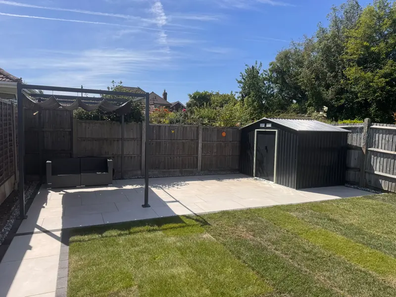 Garden with a new patio, lawn and metal shed