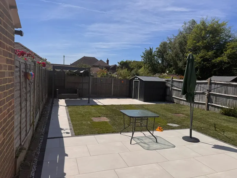 Light grey patio and newly laid lawn