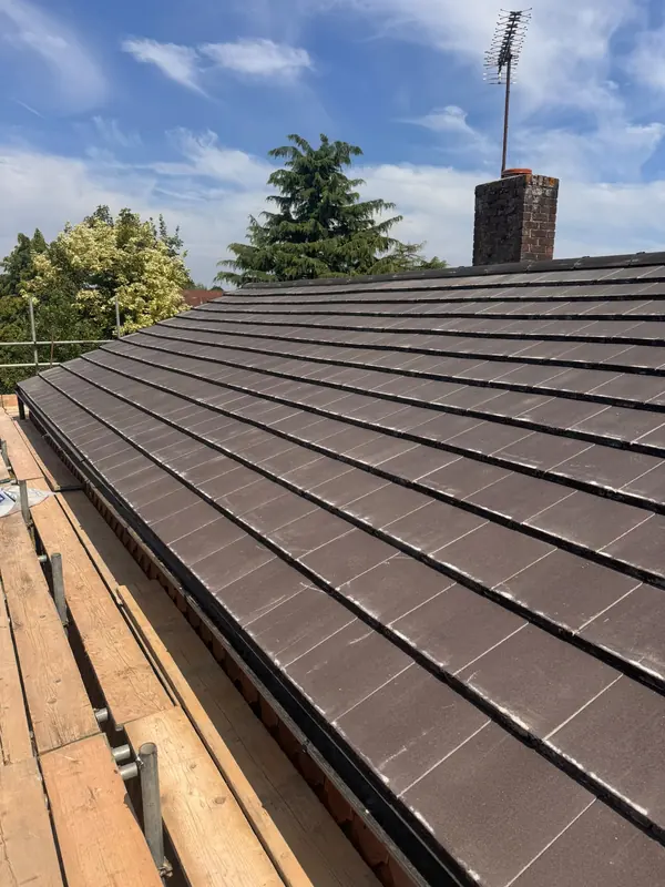 Newly re-tiled roof with the chimney behind