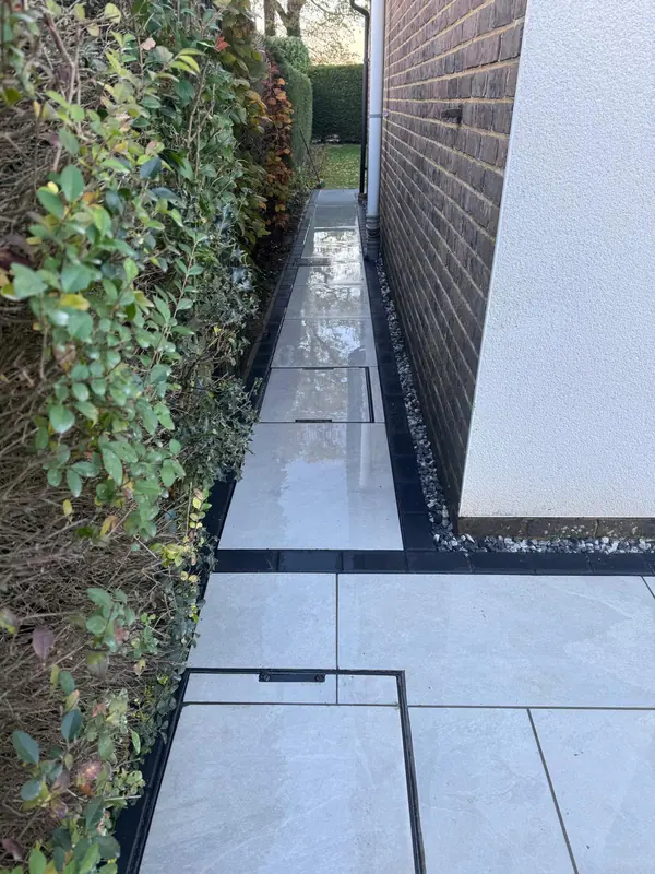 New porcelain path along the side of a house