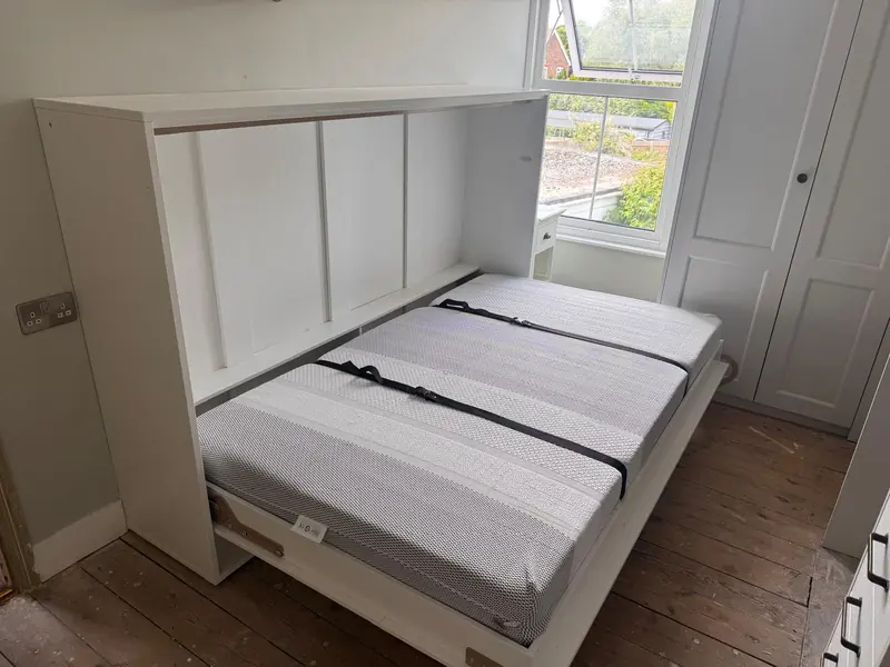 Fold-down double wall bed in a fitted cabinet